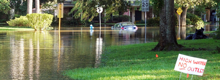 Flooding causes damage to homes and roadways.